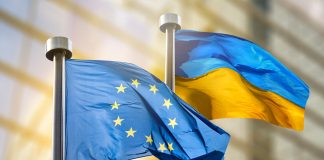 Flags of European Union and Ukraine against European Parliament bulding in Brussels, Belgium